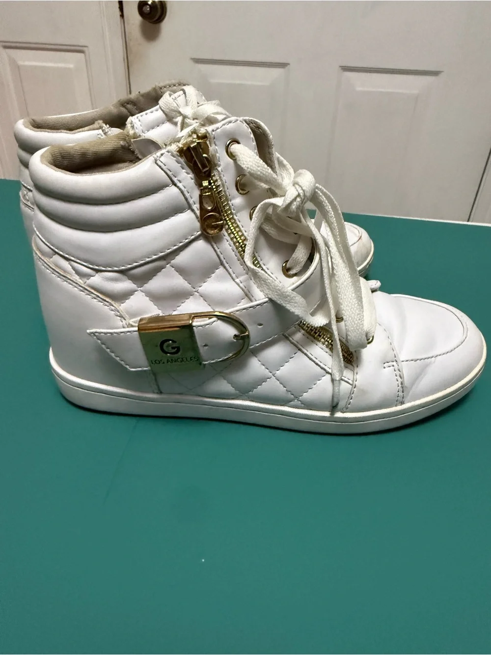 GUESS High-Top Wedge Sneakers in white faux leather.